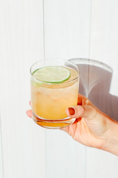 Holding a yellow liquid transparent glass
